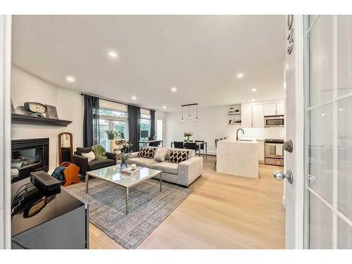 103-1634 29 Avenue Sw, Calgary, AB - Indoor Photo Showing Living Room With Fireplace