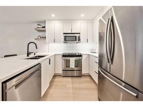 103-1634 29 Avenue Sw, Calgary, AB - Indoor Photo Showing Kitchen With Double Sink With Upgraded Kitchen