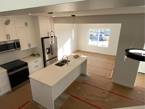 669 Lambeau Link Se, Airdrie, AB - Indoor Photo Showing Kitchen With Stainless Steel Kitchen With Double Sink