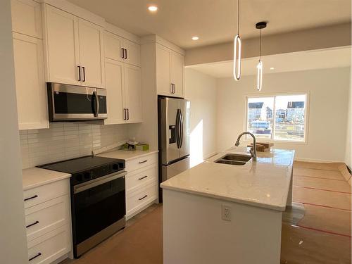 669 Lambeau Link Se, Airdrie, AB - Indoor Photo Showing Kitchen With Stainless Steel Kitchen With Double Sink With Upgraded Kitchen