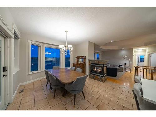 27 Corral View, Rural Rocky View County, AB - Indoor Photo Showing Dining Room With Fireplace