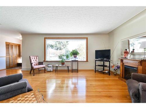 50 Grafton Crescent Sw, Calgary, AB - Indoor Photo Showing Living Room With Fireplace