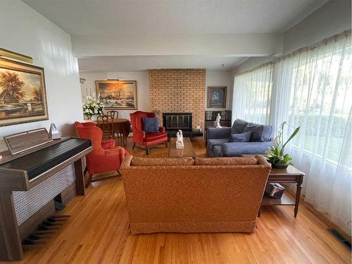 5748 Lodge Crescent Sw, Calgary, AB - Indoor Photo Showing Living Room With Fireplace