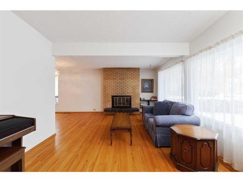 5748 Lodge Crescent Sw, Calgary, AB - Indoor Photo Showing Living Room With Fireplace