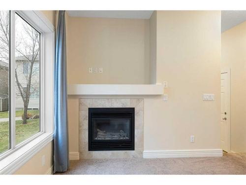 111 Bridleridge Manor Sw, Calgary, AB - Indoor Photo Showing Living Room With Fireplace