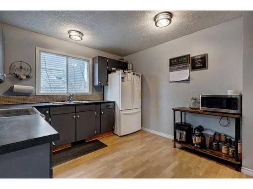 22 Hunters Gate, Okotoks, AB - Indoor Photo Showing Kitchen With Double Sink