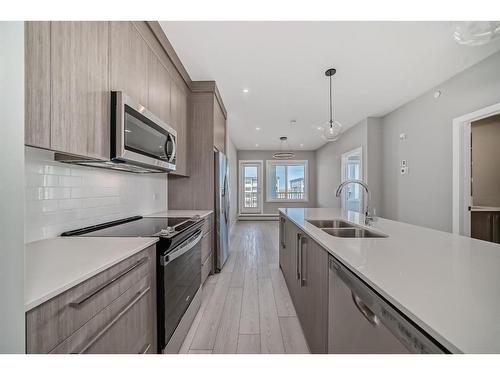 3408-111 Wolf Creek Drive Se, Calgary, AB - Indoor Photo Showing Kitchen With Double Sink With Upgraded Kitchen