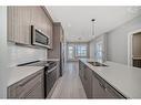 3408-111 Wolf Creek Drive Se, Calgary, AB  - Indoor Photo Showing Kitchen With Double Sink With Upgraded Kitchen 