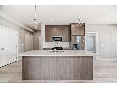 3408-111 Wolf Creek Drive Se, Calgary, AB - Indoor Photo Showing Kitchen With Stainless Steel Kitchen With Upgraded Kitchen