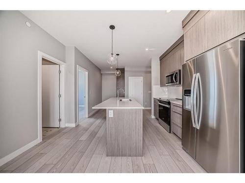 3408-111 Wolf Creek Drive Se, Calgary, AB - Indoor Photo Showing Kitchen With Stainless Steel Kitchen