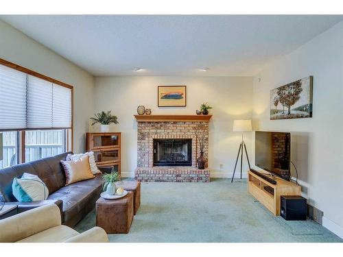 56 Woodford Close Sw, Calgary, AB - Indoor Photo Showing Living Room With Fireplace