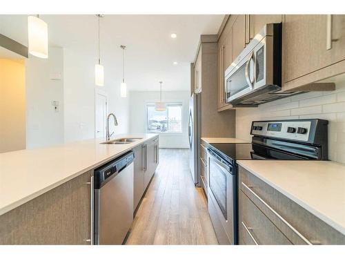 27-111 Rainbow Falls Gate, Chestermere, AB - Indoor Photo Showing Kitchen With Stainless Steel Kitchen With Double Sink With Upgraded Kitchen