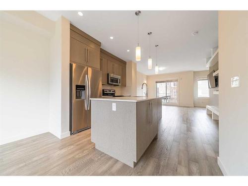 27-111 Rainbow Falls Gate, Chestermere, AB - Indoor Photo Showing Kitchen With Stainless Steel Kitchen With Upgraded Kitchen