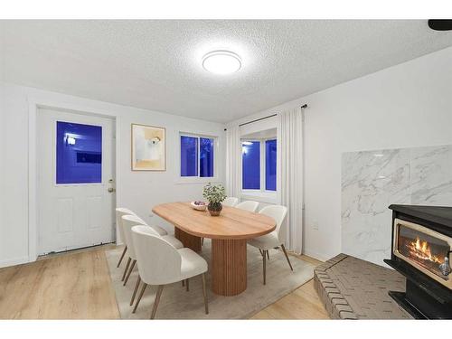 36 Abadan Crescent Ne, Calgary, AB - Indoor Photo Showing Dining Room With Fireplace