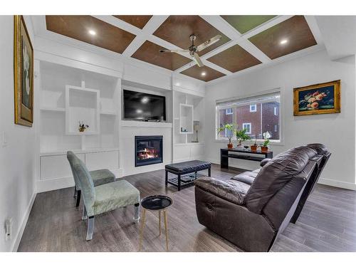 205 Kinniburgh Cove, Chestermere, AB - Indoor Photo Showing Living Room With Fireplace