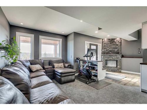 3-5242 Twp Road 290, Rural Mountain View County, AB - Indoor Photo Showing Living Room With Fireplace