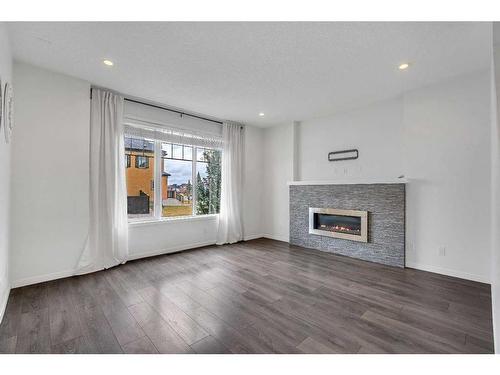 9 Marquis Link Se, Calgary, AB - Indoor Photo Showing Living Room With Fireplace