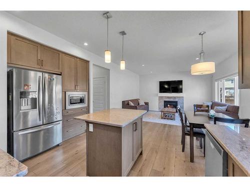 57 Saddlestone Green Ne, Calgary, AB - Indoor Photo Showing Kitchen With Fireplace