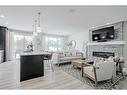 142 Seton Gardens Se, Calgary, AB  - Indoor Photo Showing Living Room With Fireplace 