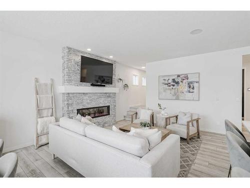 142 Seton Gardens Se, Calgary, AB - Indoor Photo Showing Living Room With Fireplace