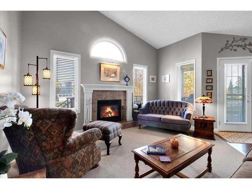 209 West Creek Springs, Chestermere, AB - Indoor Photo Showing Living Room With Fireplace