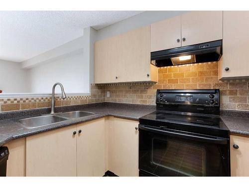 211-17 Country Village Bay Ne, Calgary, AB - Indoor Photo Showing Kitchen With Double Sink