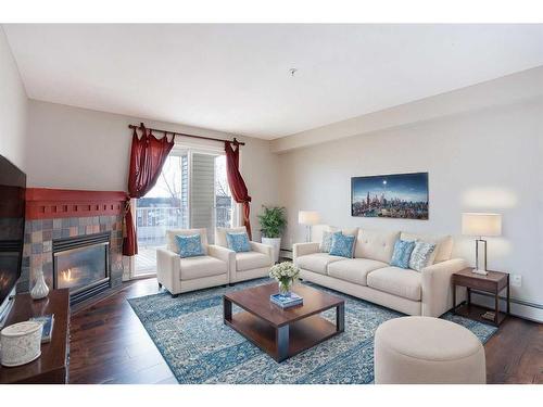 211-17 Country Village Bay Ne, Calgary, AB - Indoor Photo Showing Living Room With Fireplace