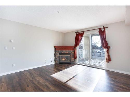 211-17 Country Village Bay Ne, Calgary, AB - Indoor Photo Showing Living Room With Fireplace