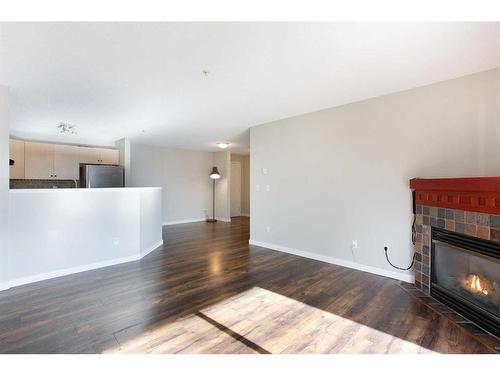 211-17 Country Village Bay Ne, Calgary, AB - Indoor Photo Showing Living Room With Fireplace