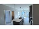 4209-111 Wolf Creek Drive Se, Calgary, AB  - Indoor Photo Showing Kitchen With Double Sink 