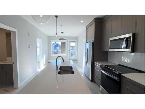 4209-111 Wolf Creek Drive Se, Calgary, AB - Indoor Photo Showing Kitchen With Double Sink