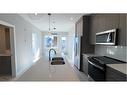 4209-111 Wolf Creek Drive Se, Calgary, AB  - Indoor Photo Showing Kitchen With Double Sink 