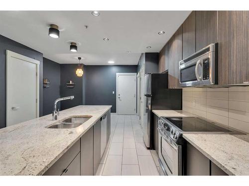 103-788 12 Avenue Sw, Calgary, AB - Indoor Photo Showing Kitchen With Double Sink With Upgraded Kitchen