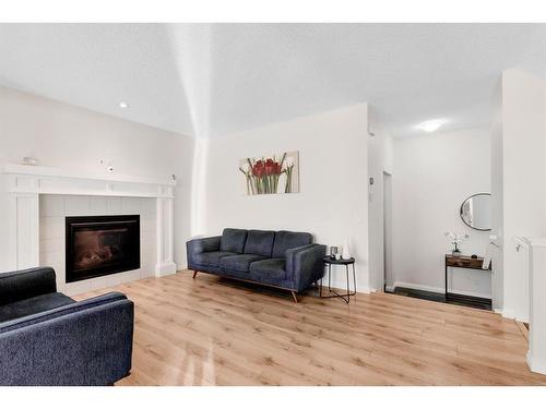 333 Clydesdale Way, Cochrane, AB - Indoor Photo Showing Living Room With Fireplace