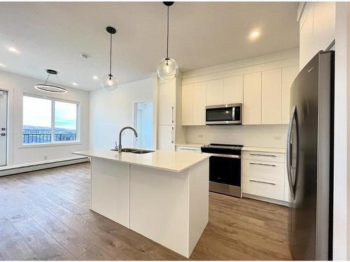 4407-111 Wolf Creek Drive Se, Calgary, AB - Indoor Photo Showing Kitchen With Stainless Steel Kitchen With Double Sink With Upgraded Kitchen