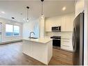 4407-111 Wolf Creek Drive Se, Calgary, AB  - Indoor Photo Showing Kitchen With Stainless Steel Kitchen With Double Sink With Upgraded Kitchen 