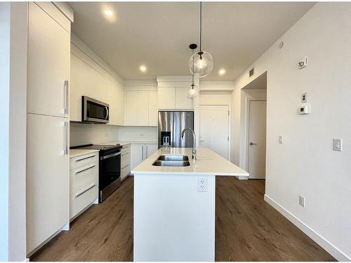 4407-111 Wolf Creek Drive Se, Calgary, AB - Indoor Photo Showing Kitchen With Stainless Steel Kitchen With Double Sink