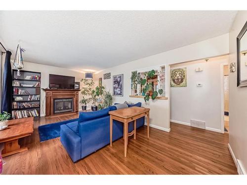 2419 39 Street Se, Calgary, AB - Indoor Photo Showing Living Room With Fireplace