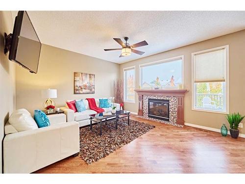 105 Aspen Stone Road Sw, Calgary, AB - Indoor Photo Showing Living Room With Fireplace