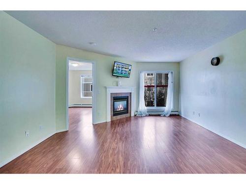 310-290 Shawville Way Se, Calgary, AB - Indoor Photo Showing Living Room With Fireplace