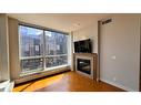 1615-222 Riverfront Avenue Sw, Calgary, AB  - Indoor Photo Showing Living Room With Fireplace 