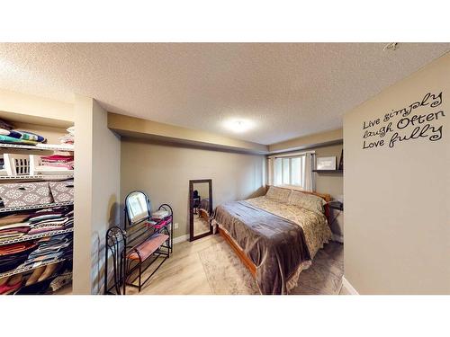 3205-403 Mackenzie Way Sw, Airdrie, AB - Indoor Photo Showing Bedroom