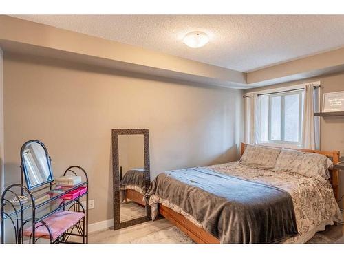 3205-403 Mackenzie Way Sw, Airdrie, AB - Indoor Photo Showing Bedroom