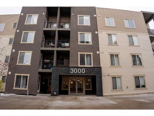 3205-403 Mackenzie Way Sw, Airdrie, AB - Outdoor With Balcony With Facade