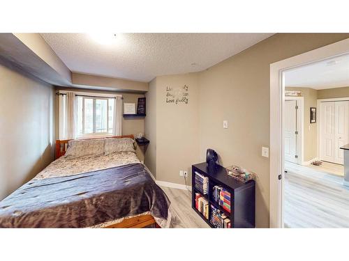 3205-403 Mackenzie Way Sw, Airdrie, AB - Indoor Photo Showing Bedroom