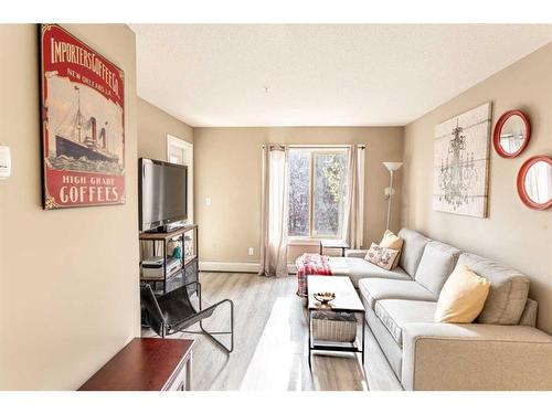 3205-403 Mackenzie Way Sw, Airdrie, AB - Indoor Photo Showing Living Room