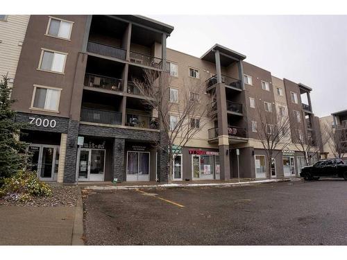 3205-403 Mackenzie Way Sw, Airdrie, AB - Outdoor With Balcony With Facade