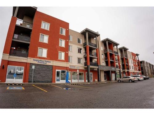 3205-403 Mackenzie Way Sw, Airdrie, AB - Outdoor With Balcony With Facade