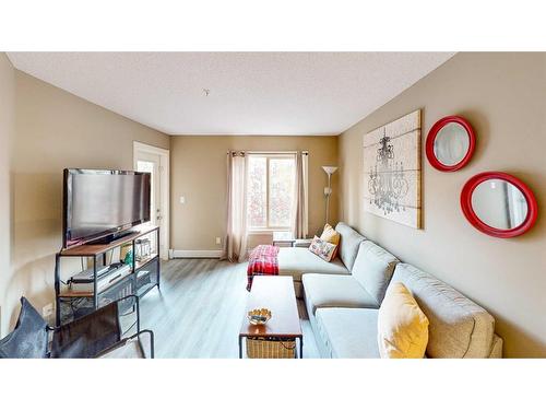 3205-403 Mackenzie Way Sw, Airdrie, AB - Indoor Photo Showing Living Room