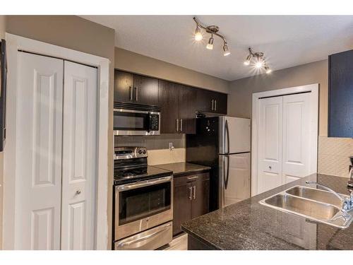 3205-403 Mackenzie Way Sw, Airdrie, AB - Indoor Photo Showing Kitchen With Double Sink